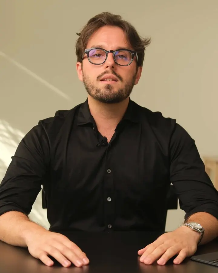 Andrea Binchi at a desk, speaking to camera