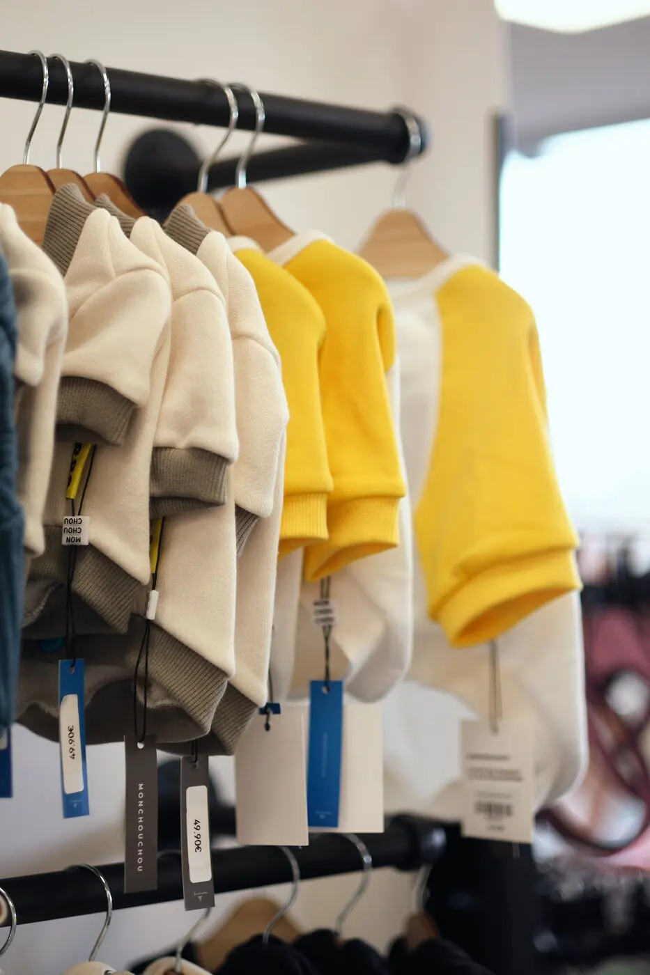 Dog sweaters on a rail in the PawsUp shop
